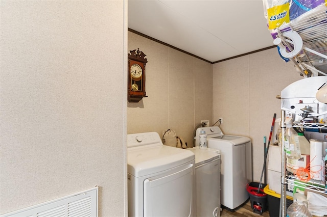 clothes washing area with ornamental molding and washing machine and clothes dryer