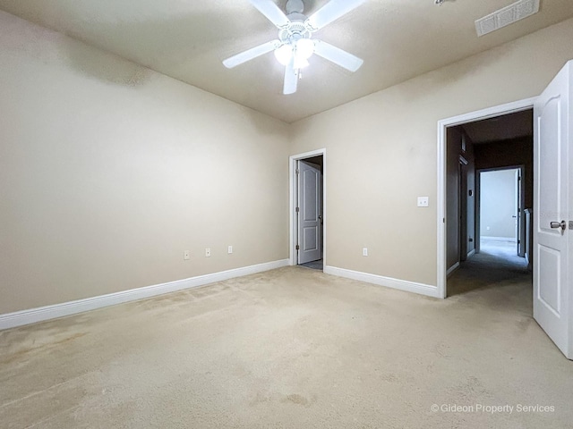 unfurnished bedroom featuring light carpet and ceiling fan