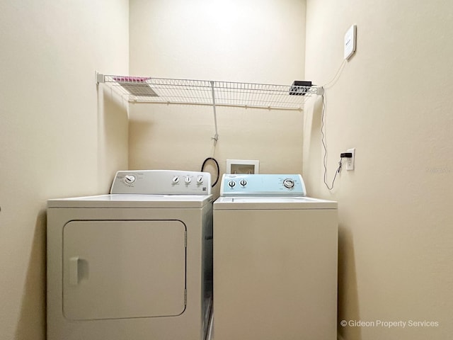 laundry area with independent washer and dryer