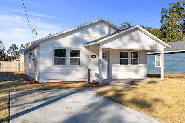 bungalow with a front yard and a porch