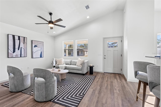 living room with ceiling fan, high vaulted ceiling, and hardwood / wood-style flooring