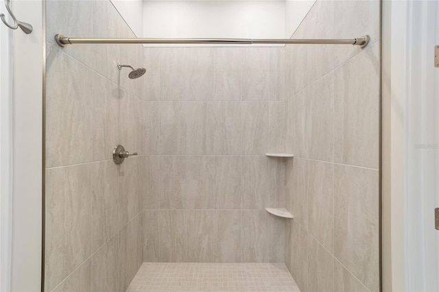 bathroom with a tile shower