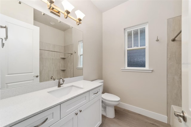 bathroom featuring vanity, hardwood / wood-style flooring, and toilet