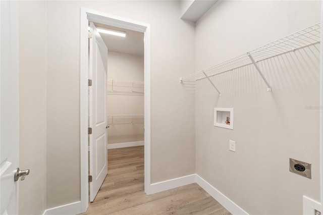 laundry room featuring hookup for an electric dryer, washer hookup, and light hardwood / wood-style floors