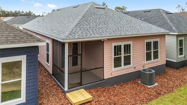 view of home's exterior with a sunroom and cooling unit