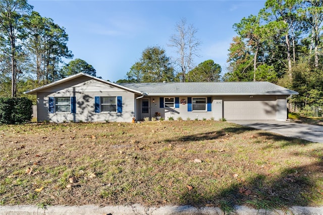 ranch-style home with a front yard and a garage