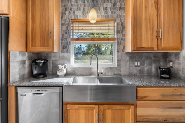 kitchen featuring decorative backsplash, stainless steel dishwasher, and sink