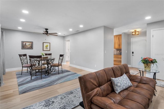 dining room with light wood-type flooring and ceiling fan