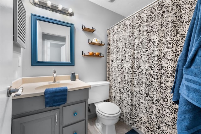 bathroom featuring tile patterned floors, vanity, and toilet