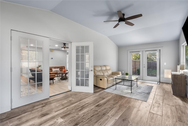 living room with ceiling fan, lofted ceiling, and french doors