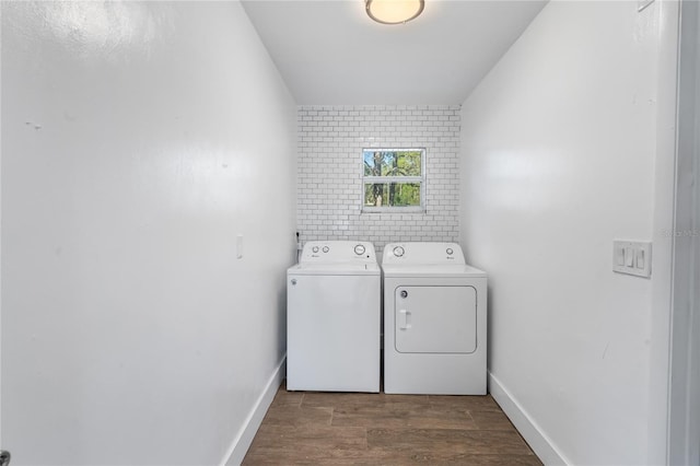 laundry area with washer and dryer and dark hardwood / wood-style floors