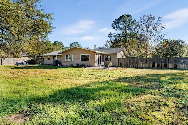 rear view of house with a lawn and a patio area