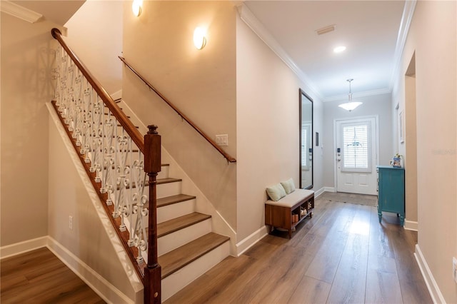 foyer entrance featuring hardwood / wood-style flooring and ornamental molding