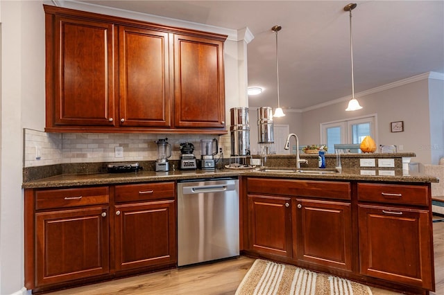 kitchen featuring sink, hanging light fixtures, stainless steel dishwasher, kitchen peninsula, and dark stone countertops