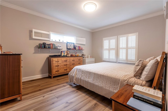 bedroom with hardwood / wood-style floors and ornamental molding