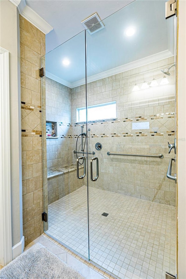 bathroom featuring crown molding and an enclosed shower