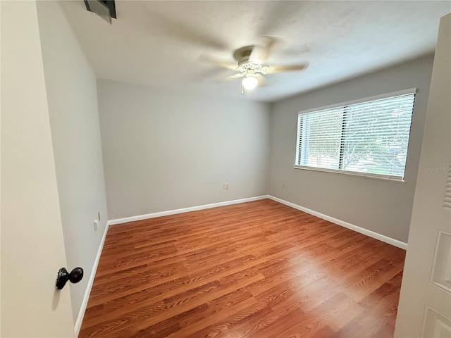 unfurnished room with ceiling fan and hardwood / wood-style floors