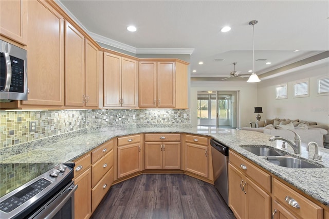 kitchen with sink, ornamental molding, stainless steel appliances, and hanging light fixtures