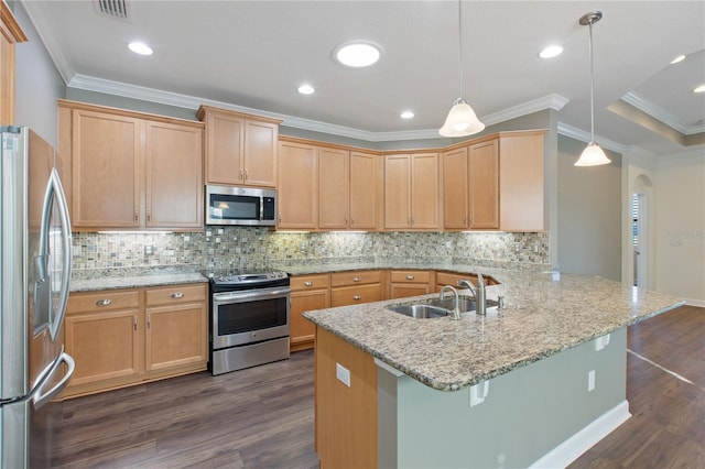 kitchen featuring a kitchen breakfast bar, sink, appliances with stainless steel finishes, decorative light fixtures, and kitchen peninsula