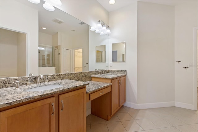 bathroom featuring tile patterned floors, vanity, and walk in shower