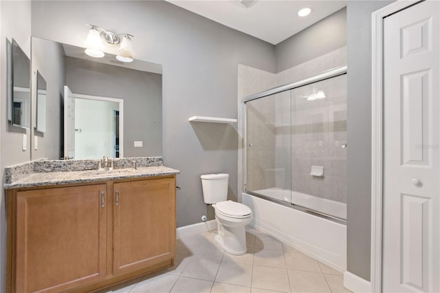 full bathroom with tile patterned floors, vanity, toilet, and bath / shower combo with glass door