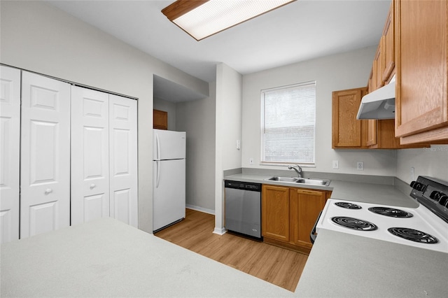 kitchen with white appliances, light hardwood / wood-style flooring, and sink