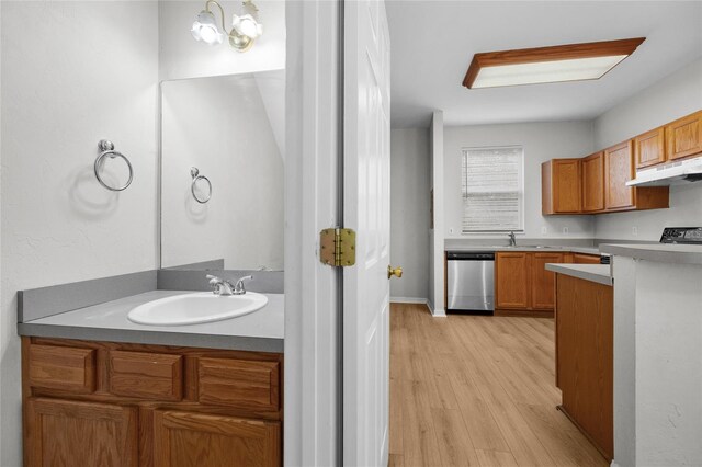 kitchen with dishwasher, light hardwood / wood-style floors, sink, and an inviting chandelier