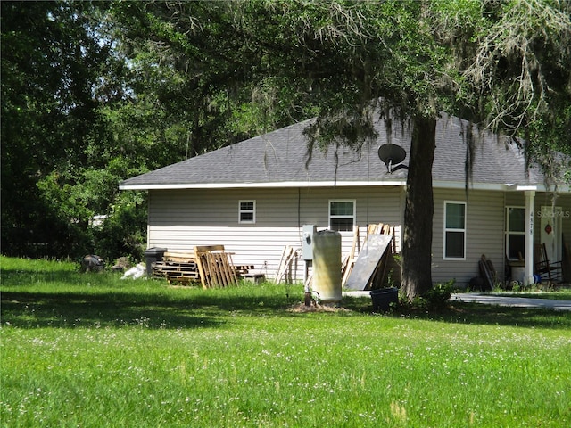 rear view of house with a yard