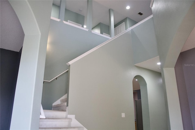 stairs featuring a high ceiling