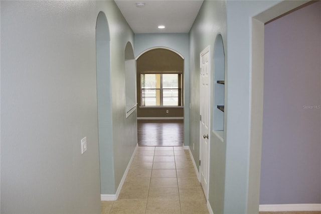 corridor featuring light tile patterned floors