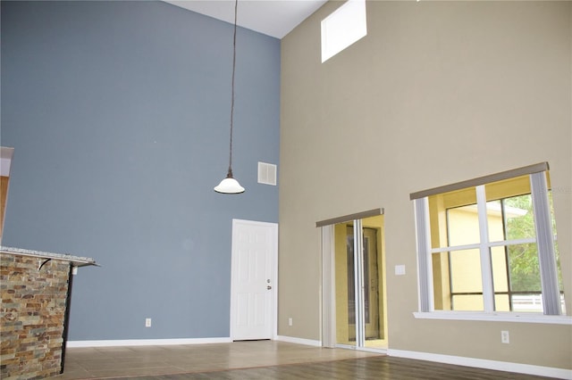 unfurnished living room featuring a high ceiling