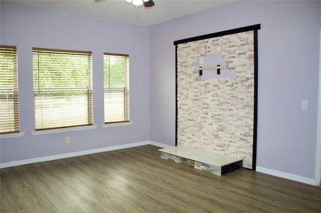 empty room featuring ceiling fan and dark hardwood / wood-style flooring