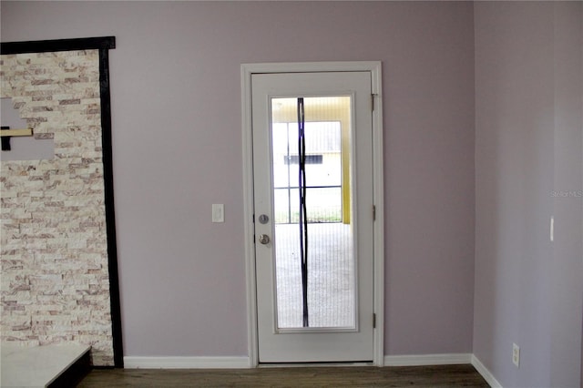 doorway to outside with dark wood-type flooring