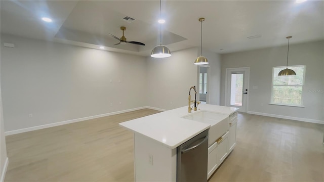 kitchen featuring a center island with sink, ceiling fan, stainless steel dishwasher, and hanging light fixtures