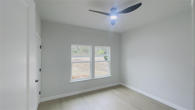 empty room featuring light hardwood / wood-style flooring and ceiling fan