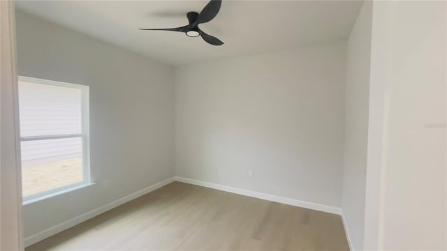 spare room featuring hardwood / wood-style flooring and ceiling fan