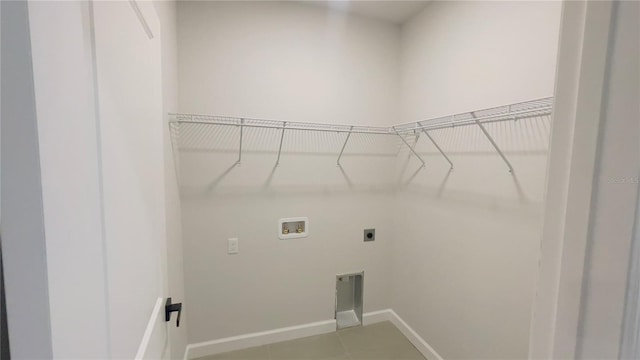 clothes washing area featuring hookup for an electric dryer, hookup for a washing machine, and tile patterned flooring