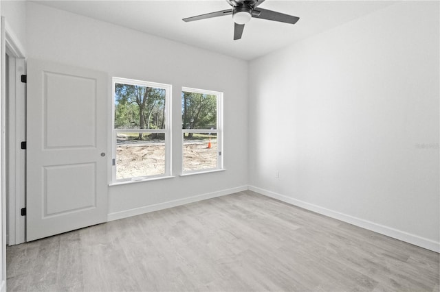 spare room featuring light hardwood / wood-style floors and ceiling fan