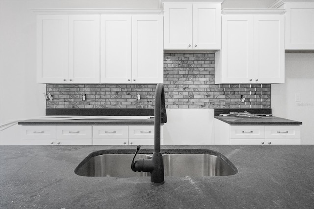 kitchen featuring white cabinets, tasteful backsplash, and sink