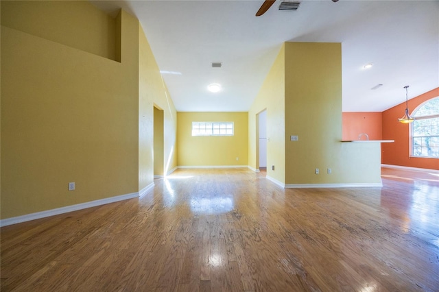 unfurnished room featuring wood-type flooring, ceiling fan, and lofted ceiling