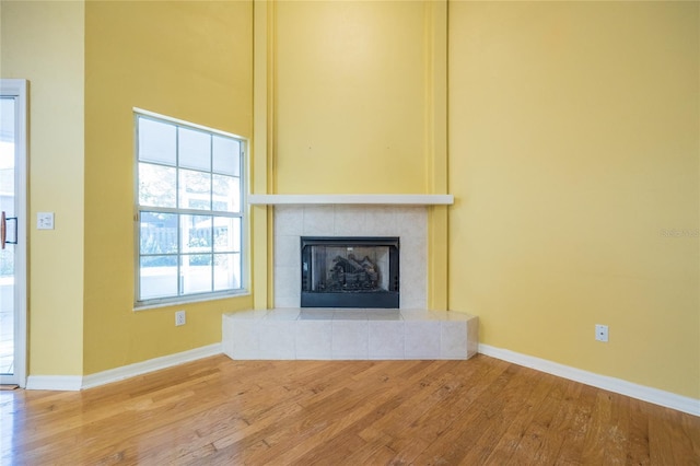 unfurnished living room with a fireplace and wood-type flooring