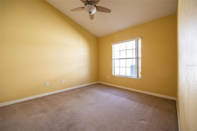 spare room featuring carpet flooring, ceiling fan, and vaulted ceiling