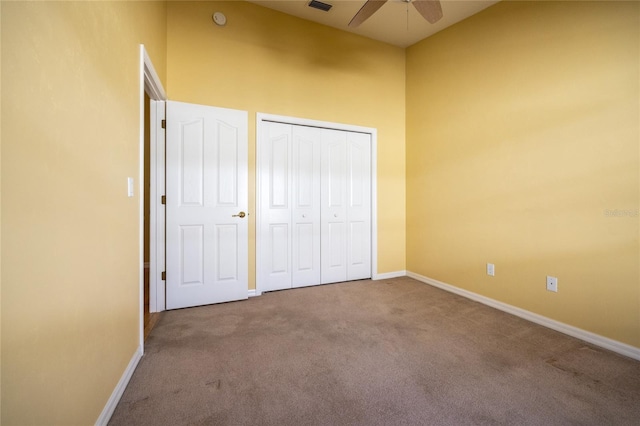 unfurnished bedroom with carpet flooring, a closet, and ceiling fan