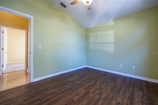 empty room featuring ceiling fan, dark hardwood / wood-style flooring, and vaulted ceiling