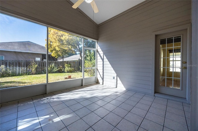 unfurnished sunroom featuring ceiling fan and lofted ceiling