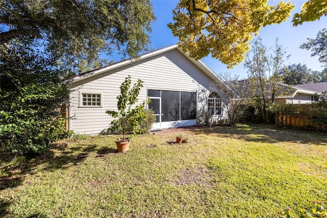 back of house featuring a lawn