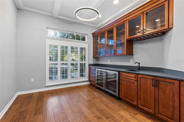 bar with beverage cooler, dark wood-style floors, wet bar, a sink, and beam ceiling