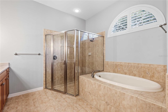 full bath featuring a shower stall, a garden tub, and vanity