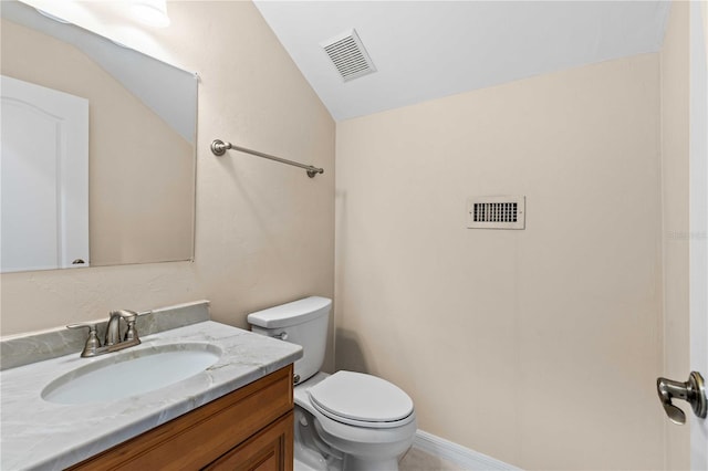 half bath featuring vaulted ceiling, visible vents, vanity, and toilet