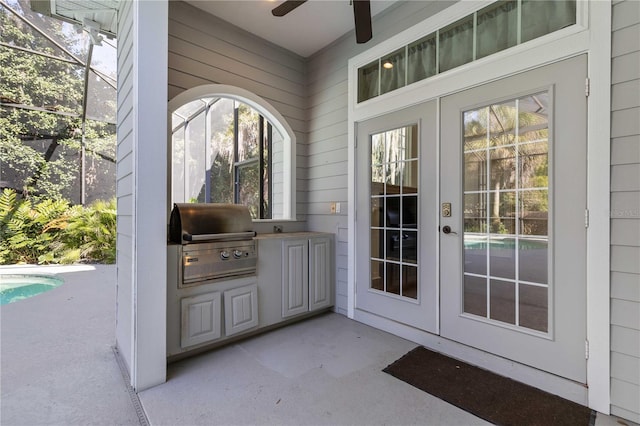 doorway to outside featuring wooden walls, a ceiling fan, and french doors